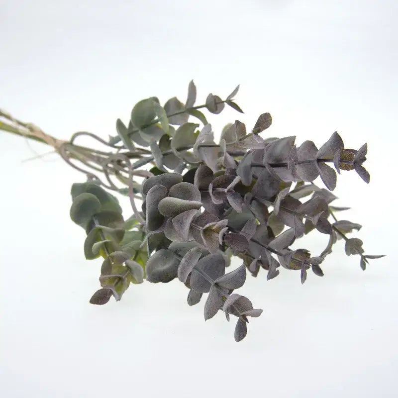 A bundle of decorbites eucalyptus leaves artificial in muted gray and soft green tones tied with natural twine for living room decor