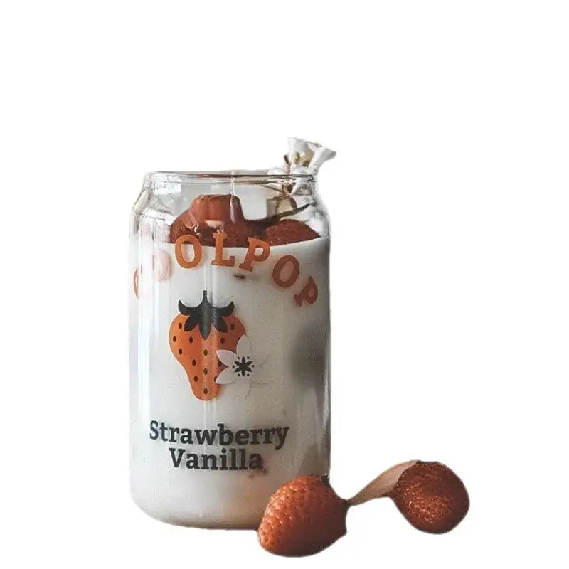 Peach print can shape glass cup with fruit prints filled with creamy white liquid featuring strawberry vanilla label