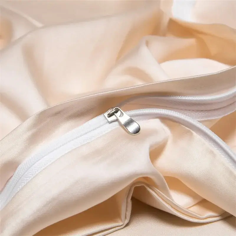 Cream-colored satin pillowcase with silver zipper part of peach satin cooling cotton solid bedding set for bedroom