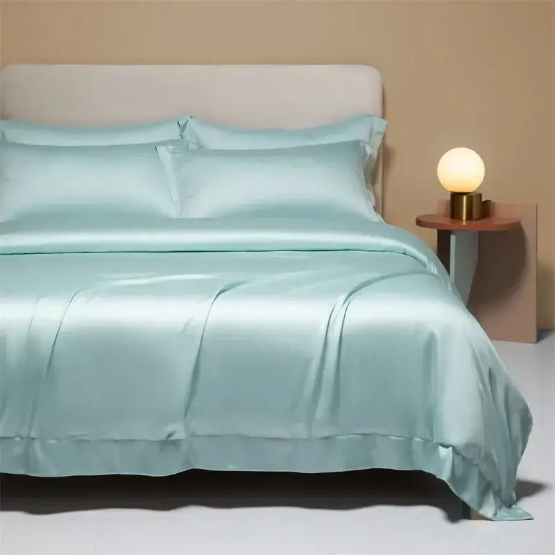 A smooth light blue satin bedding set featuring cooling cotton solid material with matching duvet and pillows