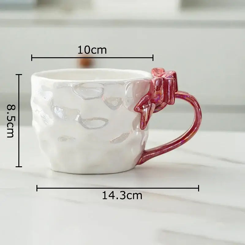 White ceramic mug with textured hammered finish and vibrant pink decorbites bowknot handle porcelain design