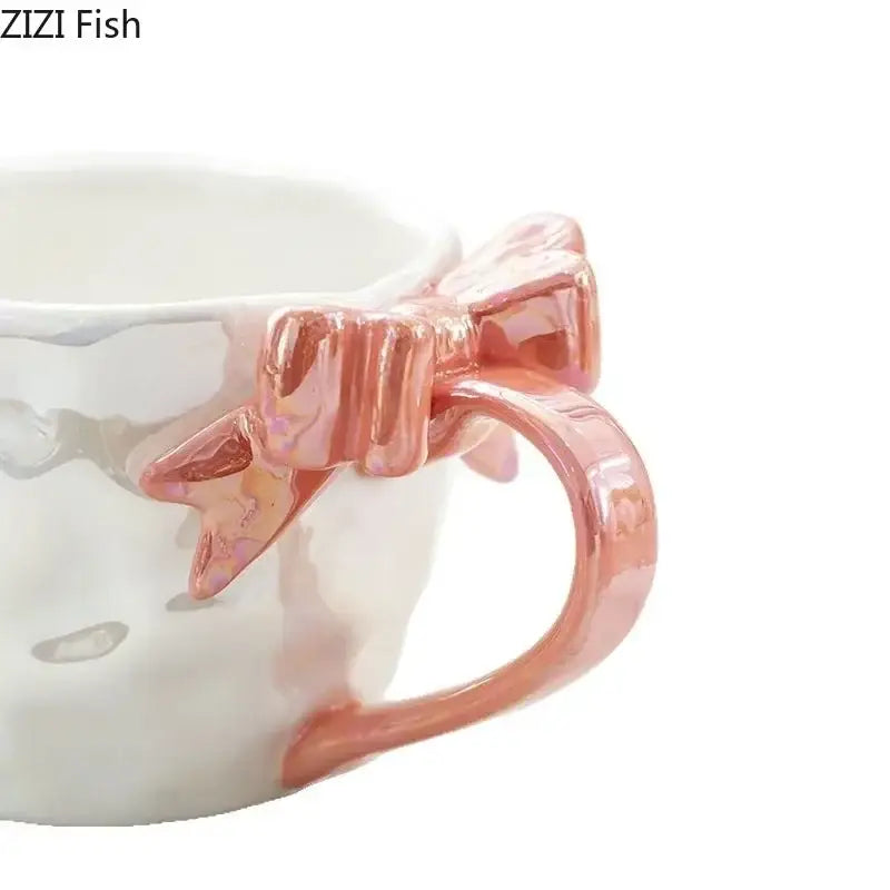 A white ceramic mug with a glossy rose gold bowknot handle porcelain design from decorbites bowknot handle set