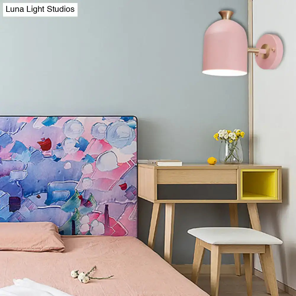 Pink and brass macaron wall light sconce lamp with bell-shaped cup shade and brass-finished base for dining room use