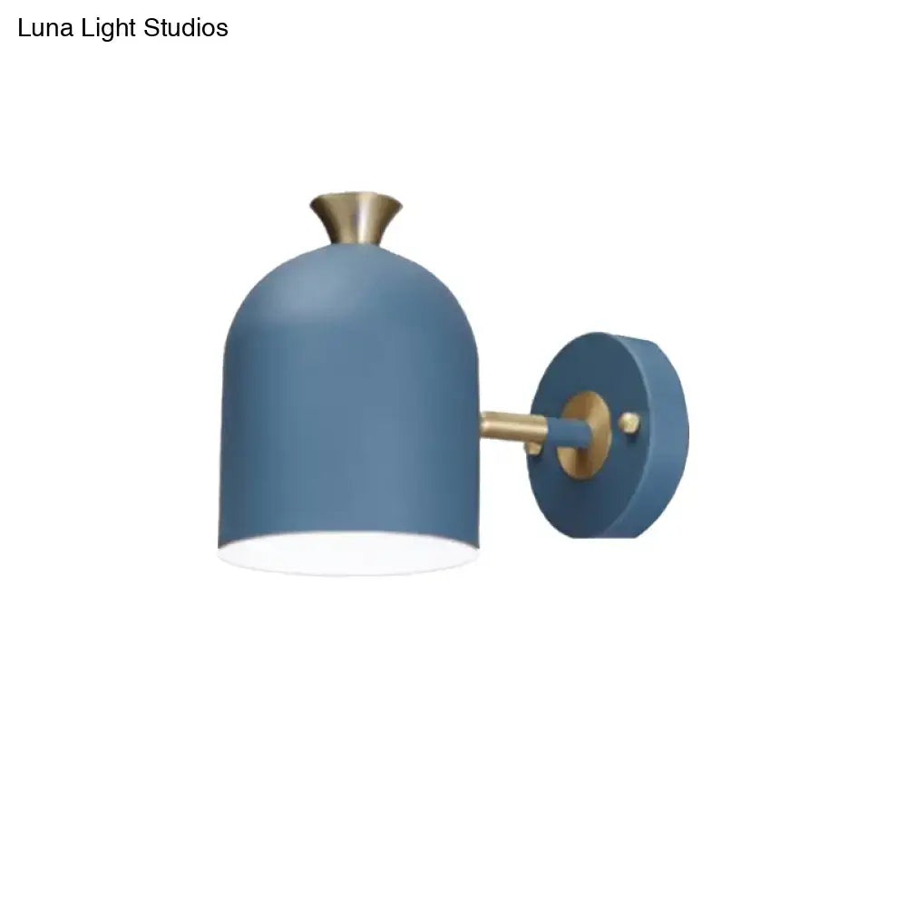Blue matte-finished wall light sconce lamp with brass accents and sleek cup shade for modern dining room use