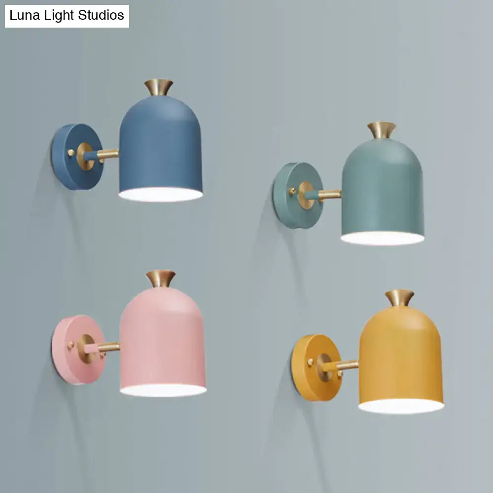 Set of four modern pastel wall light sconce lamps with cup shades and brass accents for dining room lighting