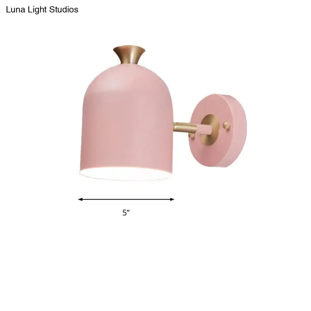 Soft pink dome-shaped wall light sconce lamp with brass finish and cup shade for dining room use