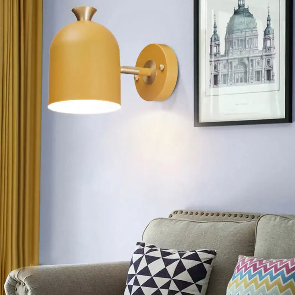 Warm yellow matte-finished wall light sconce lamp with cup shade in pink and brass for dining room lighting