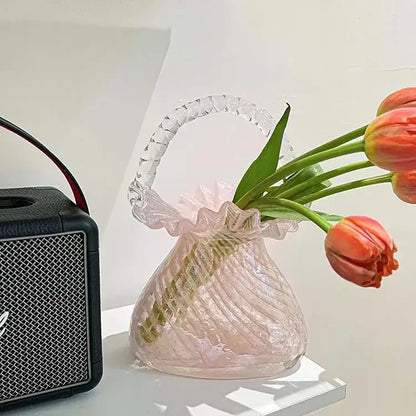 Pink and clear decorbites crystal flower basket glass vase with ribbed design and faceted handle holding orange tulips
