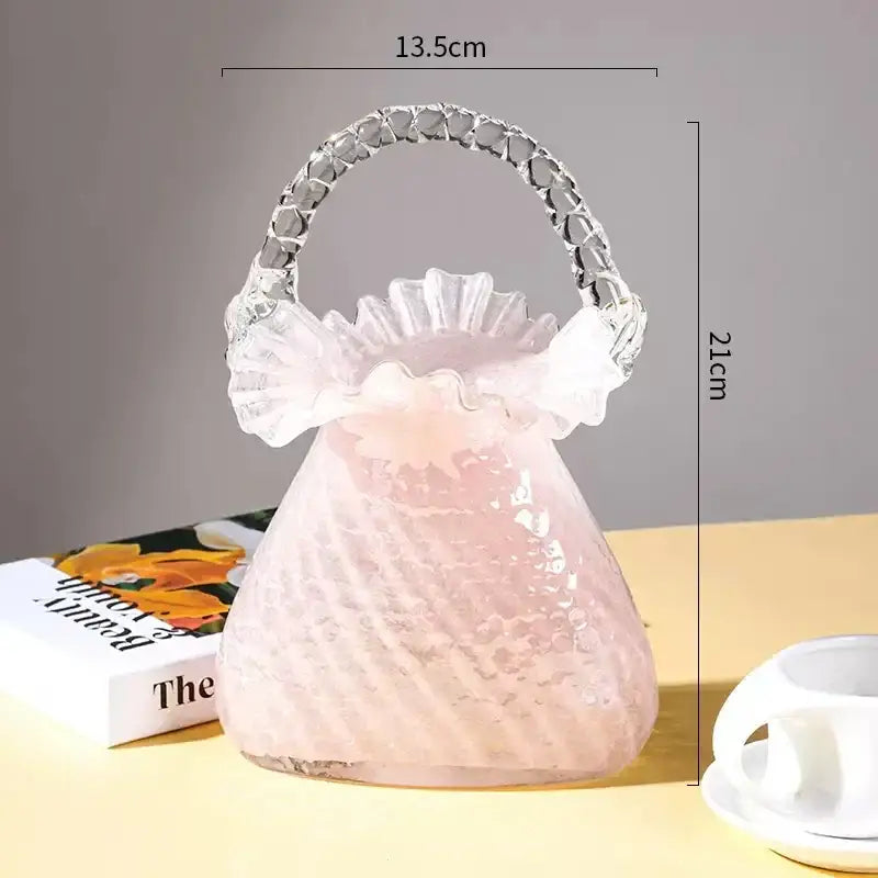 Translucent pink glass handbag with ruffled top and clear crystal handle used as decorbites crystal flower basket vase