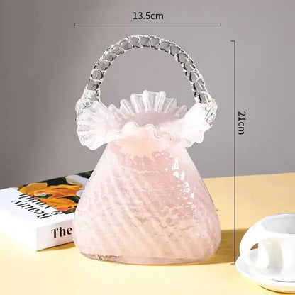 Translucent pink glass handbag with ruffled top and clear crystal handle used as decorbites crystal flower basket vase