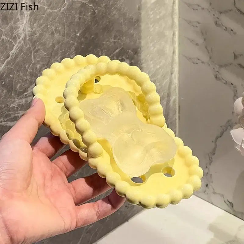 Yellow silicone soap dish with scalloped edge and translucent bunny insert for dish drainage rack bathroom accessory