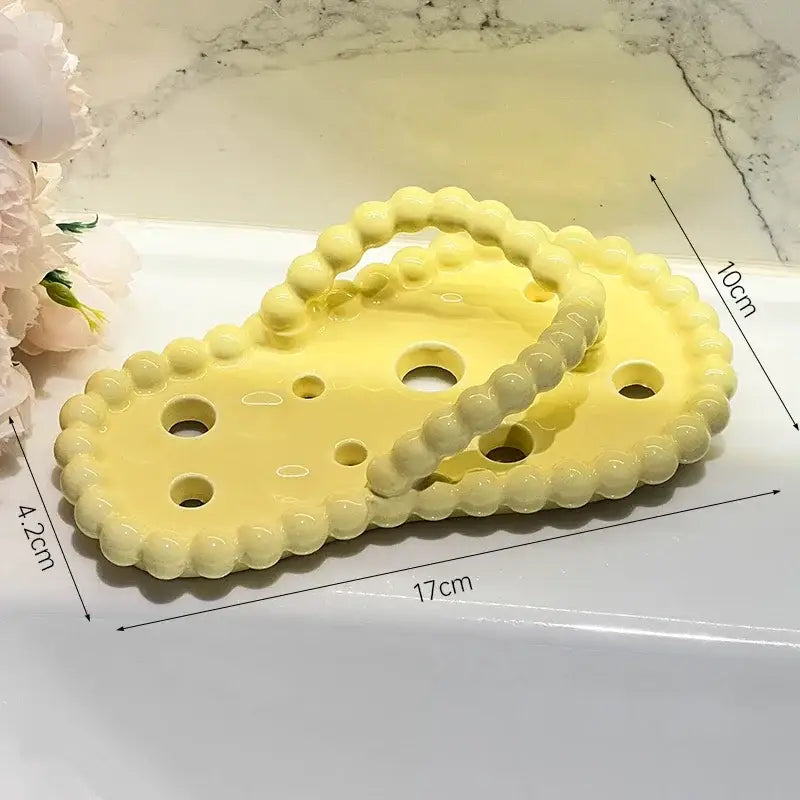 Pastel yellow ceramic cheese-shaped soap dish with beaded edge and hole details for soap dish drainage rack use