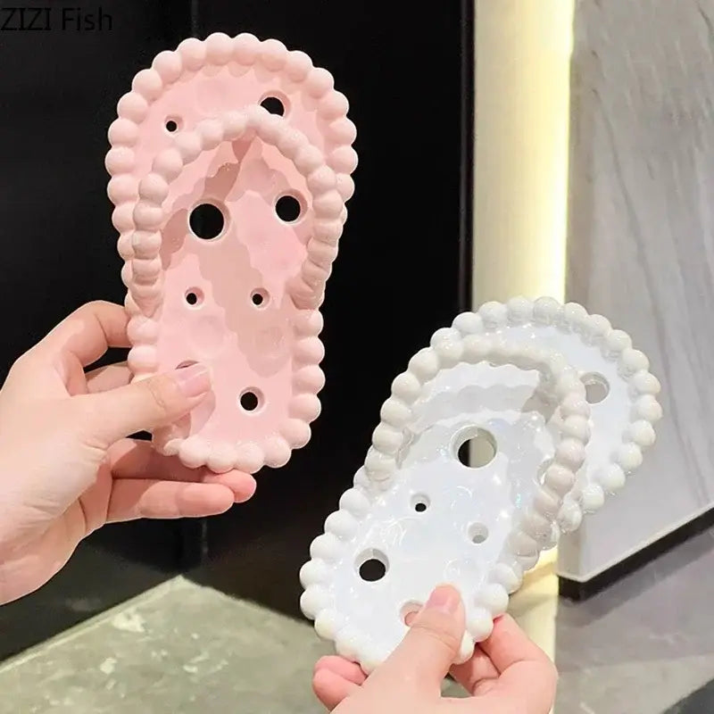 Pink and white silicone flip-flop shaped shoe inserts with beaded edge design for soap dish drainage rack use