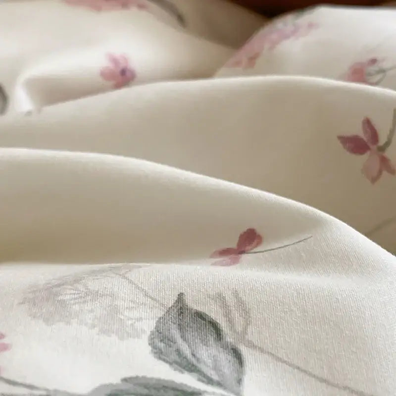 Cream-colored bedding set with delicate pink and gray floral egyptian cotton print for bedroom use