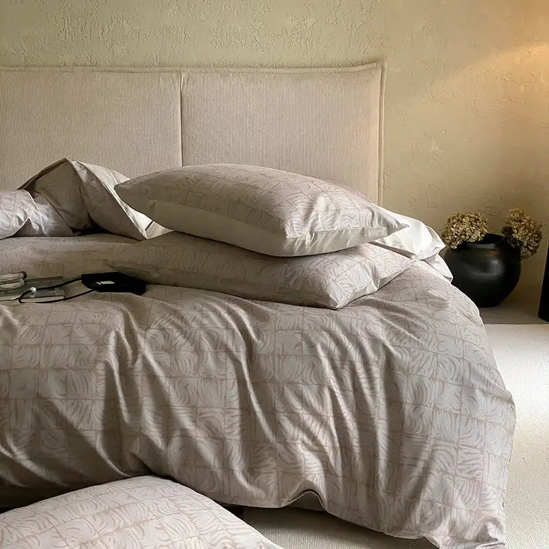 Beige linen duvet bedding set with subtle leaf-patterned embroidery and pink and cream floral egyptian cotton print design