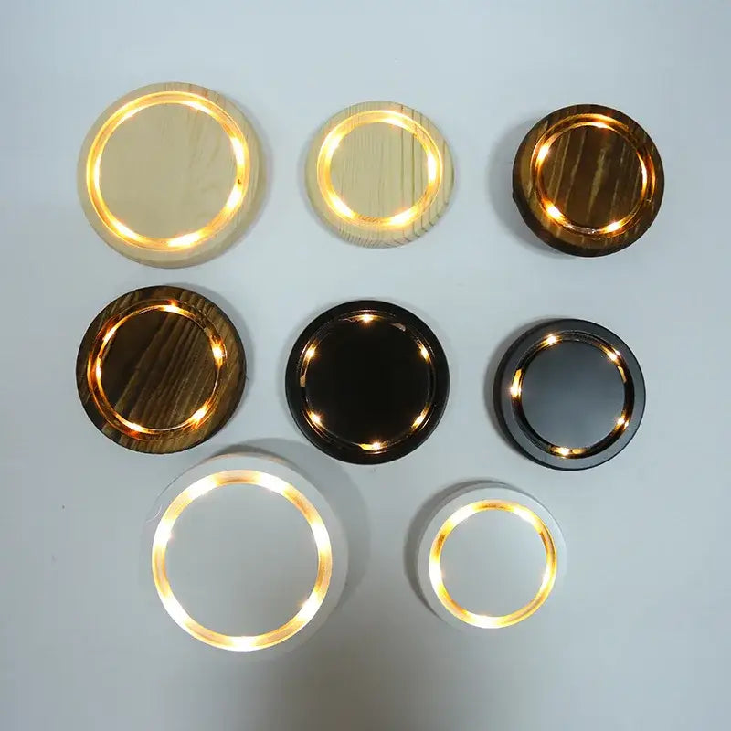 Circular led wall sconces with warm glow in wood-grain and matte finishes complement pink and gold dry flower ornaments glass dome night light