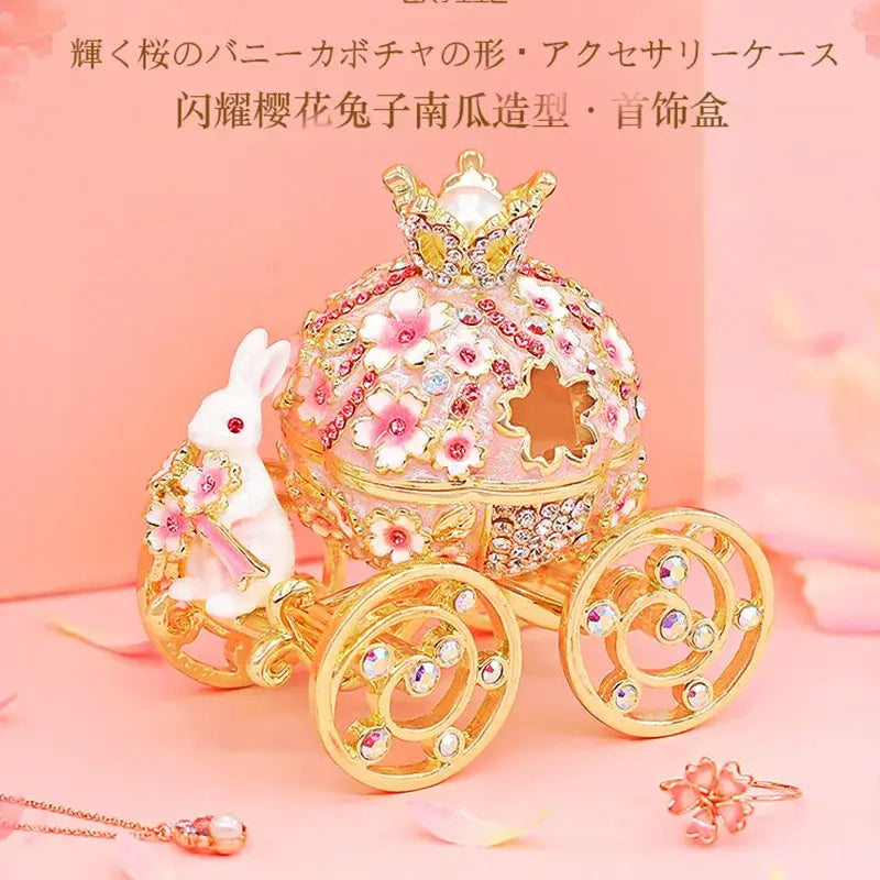 Pink and gold princess carriage jewelry trinket box with cherry blossom motifs and a white rabbit figurine for bedroom decor