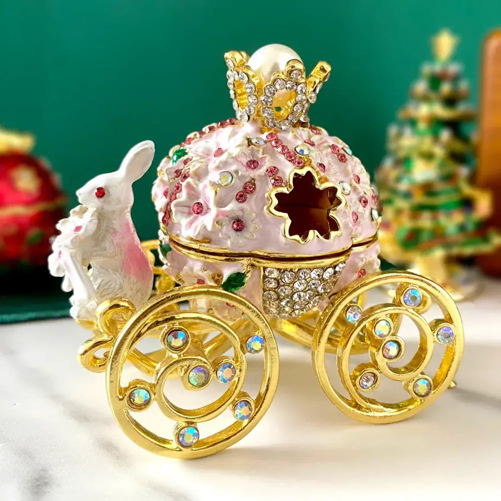 Pink and gold princess carriage jewelry trinket box with ornate rhinestones floral patterns and golden wheels for decor