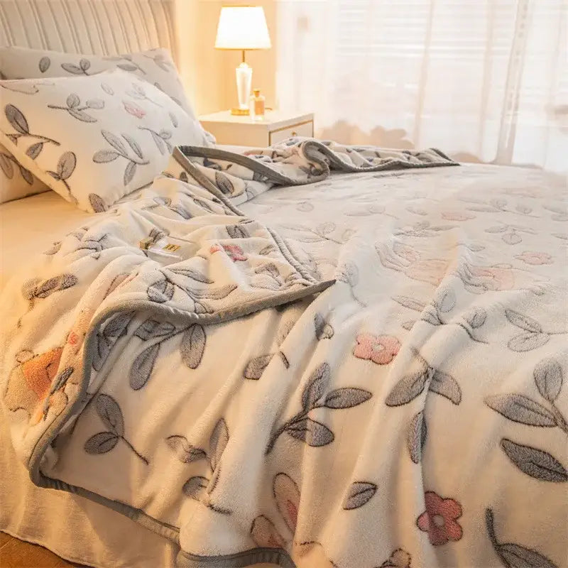 Soft cream-colored fleece blanket with embroidered gray leaves and pink flowers and matching gray border double sided plaid fleece