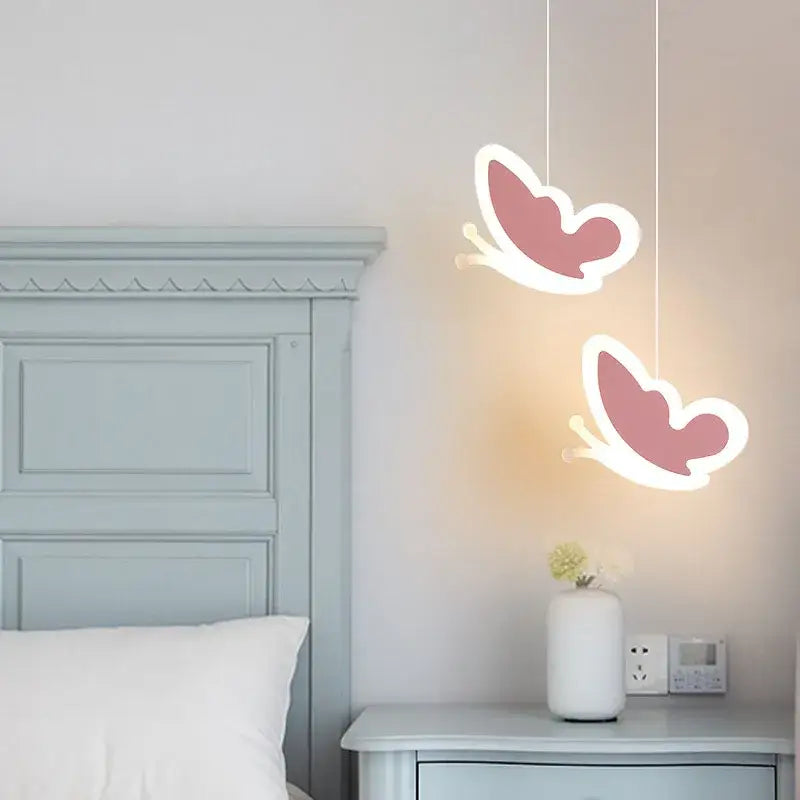 Two pink heart blossom butterfly led pendant lights with white outlines hang from the ceiling in bedroom chandelier