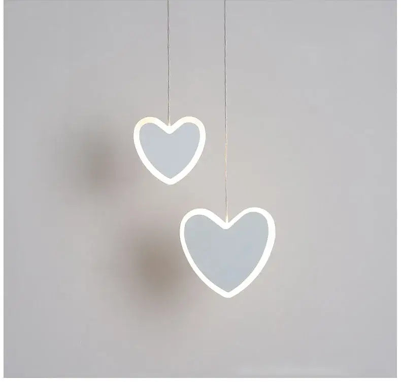 Two minimalist heart blossom butterfly led pendant lights with glowing white outlines and soft gray centers for bedroom lighting