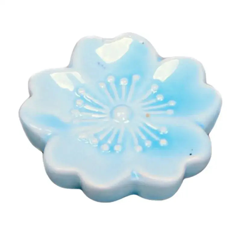 A light blue ceramic sakura chopstick rest with white detailing perfect for decorbites ceramic sakura dining decor