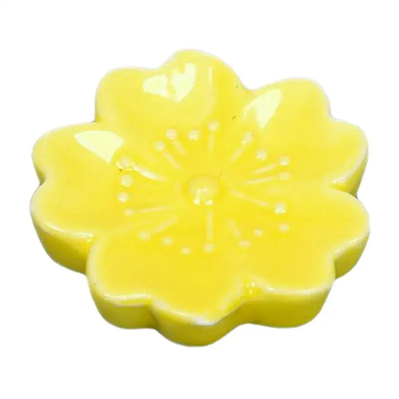 A glossy yellow ceramic flower-shaped soap dispenser with detailed petals and embossed center for decorbites ceramic sakura chopstick rest dining room decor