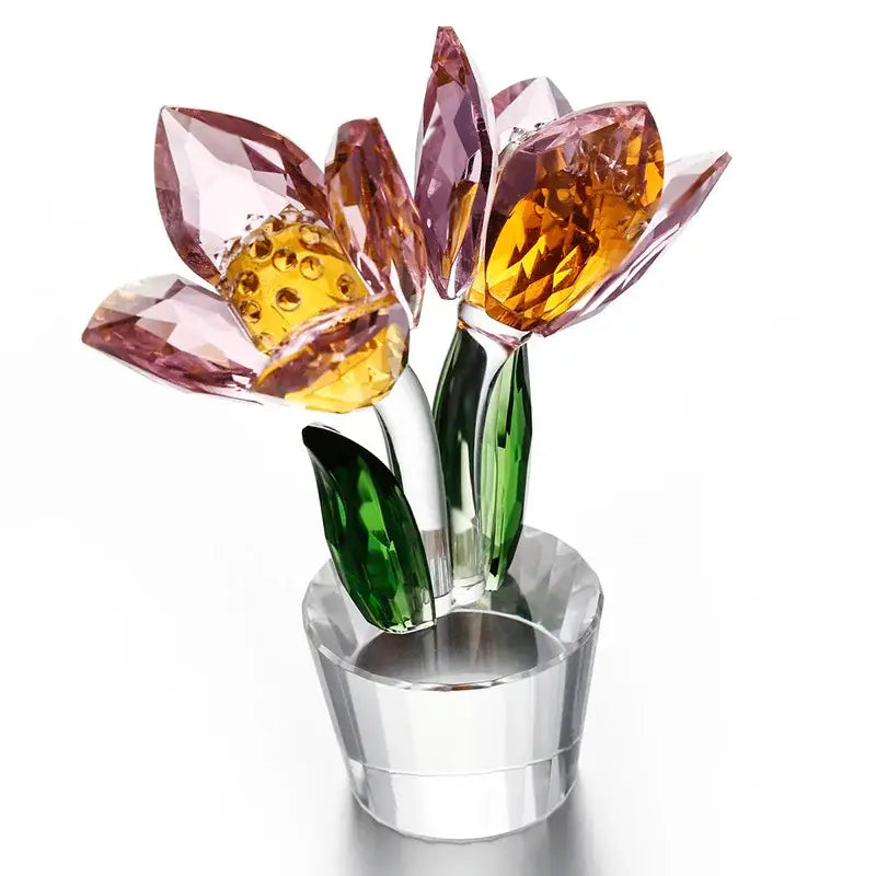 A sparkling pink and amber crystal tulip lily flower sculpture with green leaves in a clear glass pot for decorbites decor