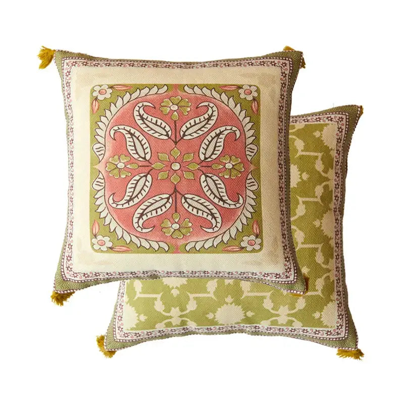Square cushion with vibrant pink and green datura flowers print, cream border, and mustard-yellow tassels for living room decor