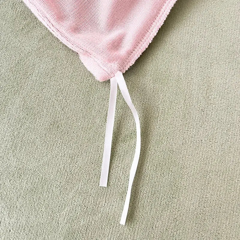 A soft pink milk velvet bedding set with textured weave and white drawstrings for winter bedroom comforter