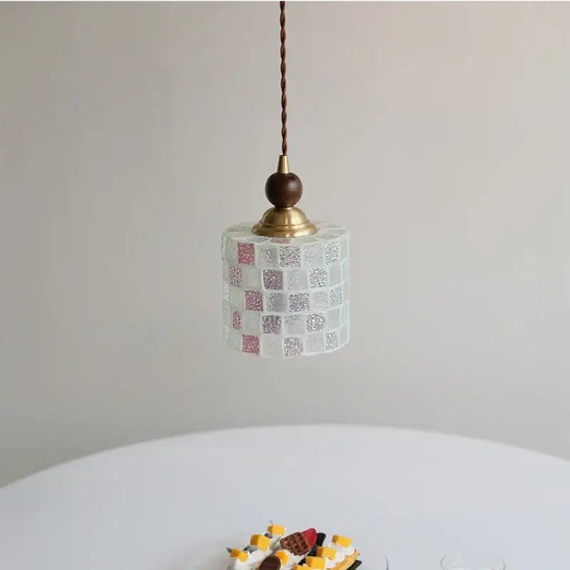 Delicate pink and lavender mosaic glass ball led pendant light with white and pink tiles brass fixture and dark cord