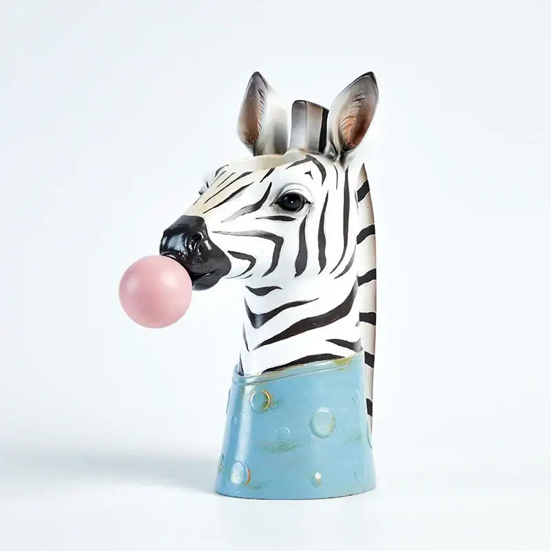 Whimsical zebra-shaped resin flower vase with black and white stripes and pink bubble gum girl bubble on light blue base decorbites bubble gum decor