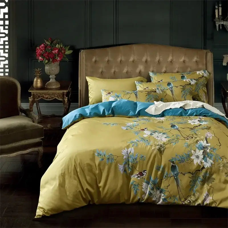 Yellow satin duvet cover with blue and white floral and bird patterns in pink and teal egyptian cotton bedding set
