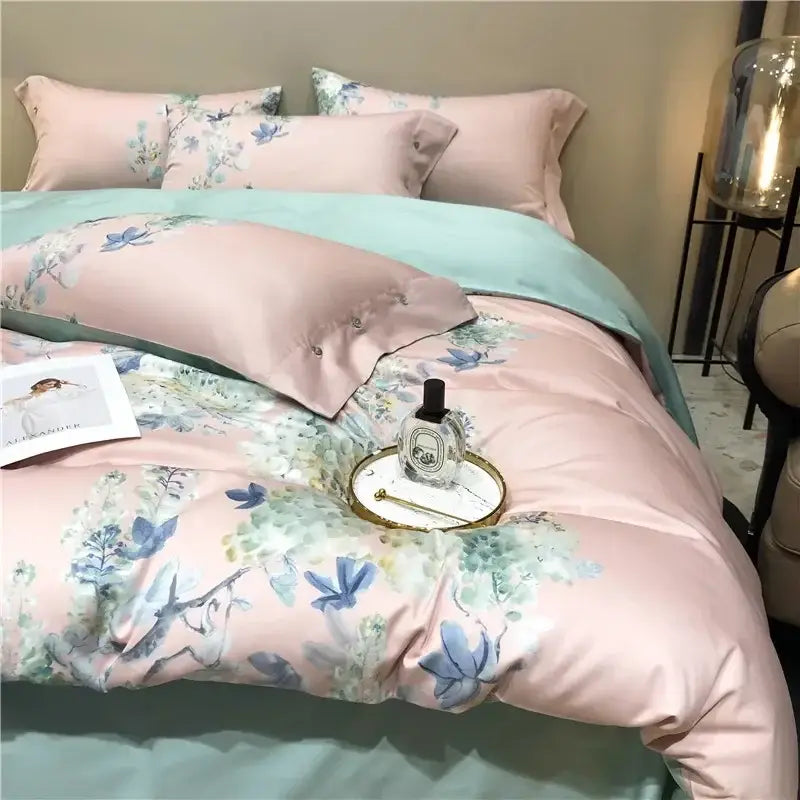Pink satin duvet cover with blue and green floral pattern and matching pillowcases in egyptian cotton bedding set