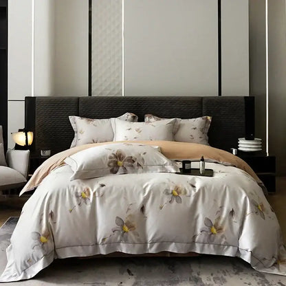 White satin duvet cover with beige and yellow floral pattern and stitched hem in pink and teal egyptian cotton bedding set