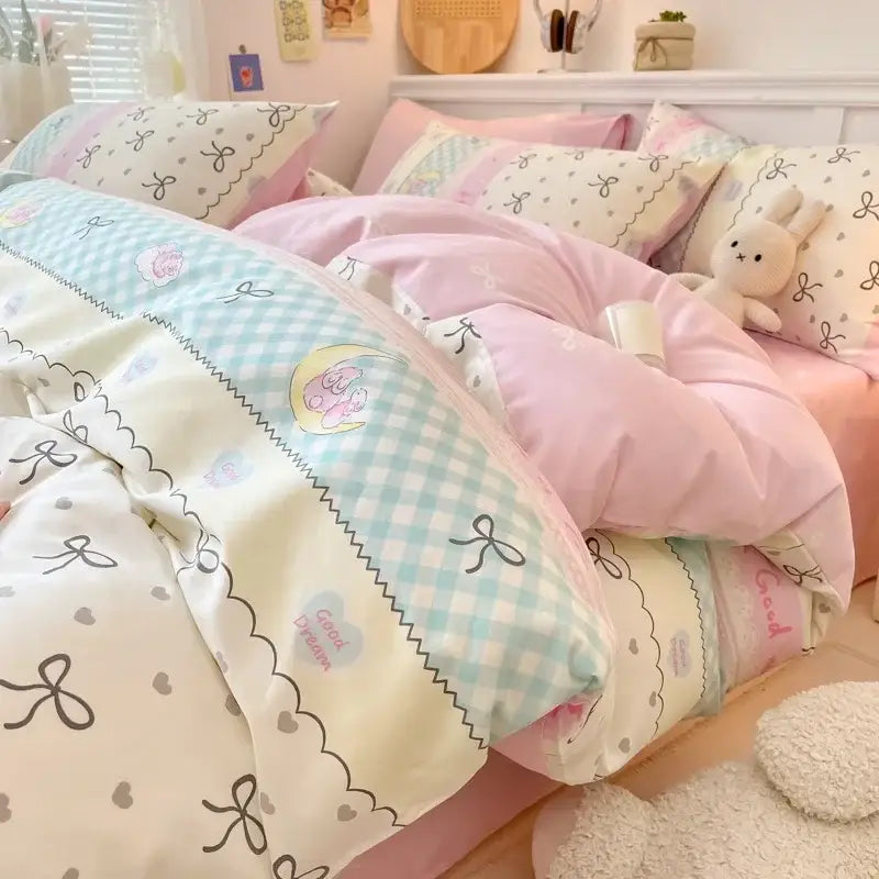 Pink and white cartoon printed cotton quilt cover featuring pastel pink and mint green patchwork with embroidered bows hearts and a sleeping bunny design by decorbites cartoon printed