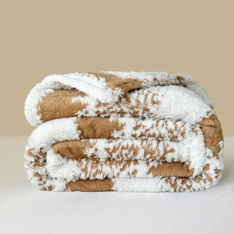 A plush cationic jacquard blanket by decorbites featuring a soft brown and white faux fur pattern for cozy decor