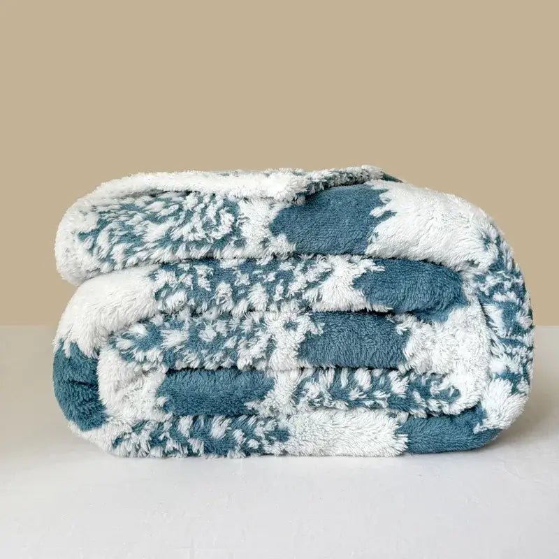 A cozy teal and white plush decorbites cationic jacquard blanket with soft textured pattern for bedroom decor