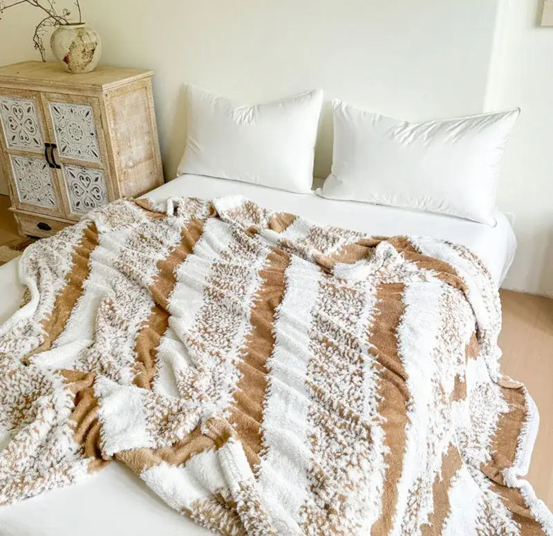 A plush cationic jacquard blanket with cream and tan stripes featuring a soft textured surface by decorbites cationic jacquard