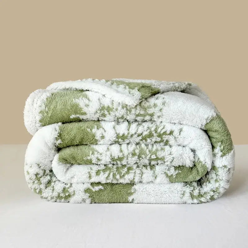 A plush olive green and white sherpa decorbites cationic jacquard blanket with soft textured surface for cozy decor