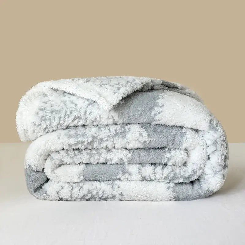 A plush gray and white patterned fleece decorbites cationic jacquard blanket with a soft textured surface for bedroom use