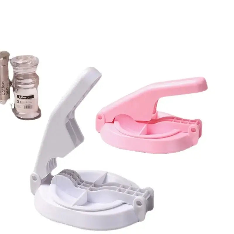 Pink and white plastic dumpling wrapper presser mold with hinged handle design for kitchen baking tool use