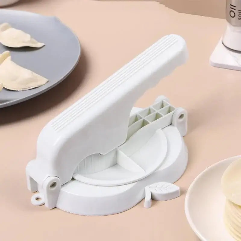 White plastic dumpling wrapper presser mold with leaf-shaped handle and segmented plates for baking tool use