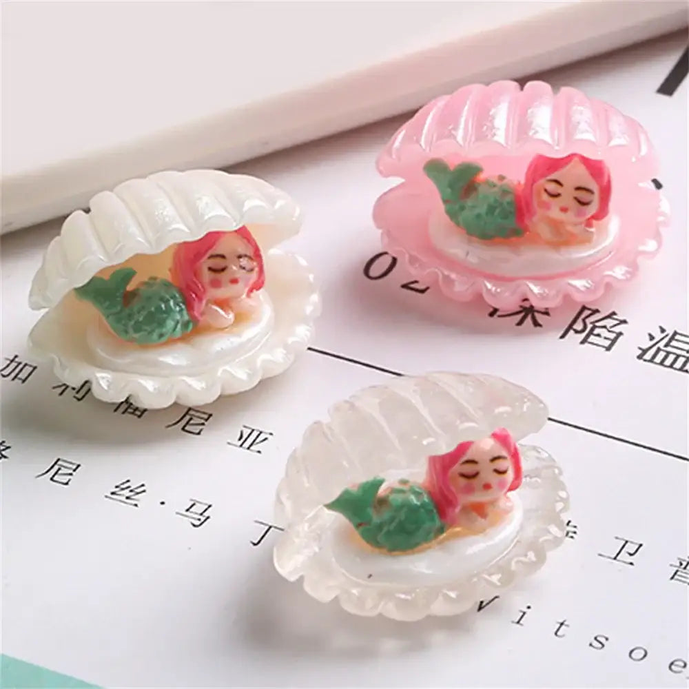 Pink and white resin seashell figurines with sleeping mermaids pink hair green tails decorbites colorful plated bedroom decor