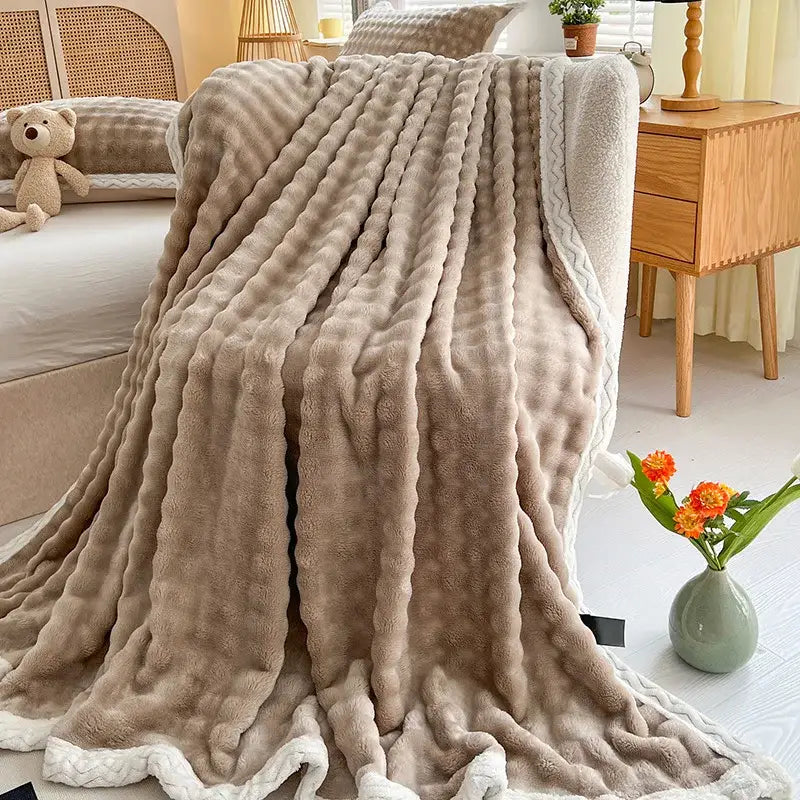 Beige plush throw blanket with ribbed knit pattern and white braided trim from decorbites cozy faux rabbit fur collection