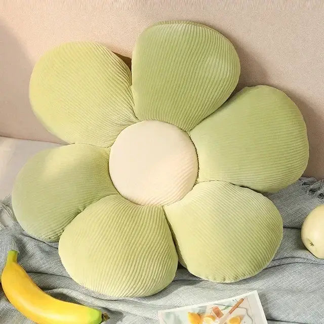 A soft light green corduroy flower-shaped lumbar support cushion with cream center for decorbites daisy lumbar support