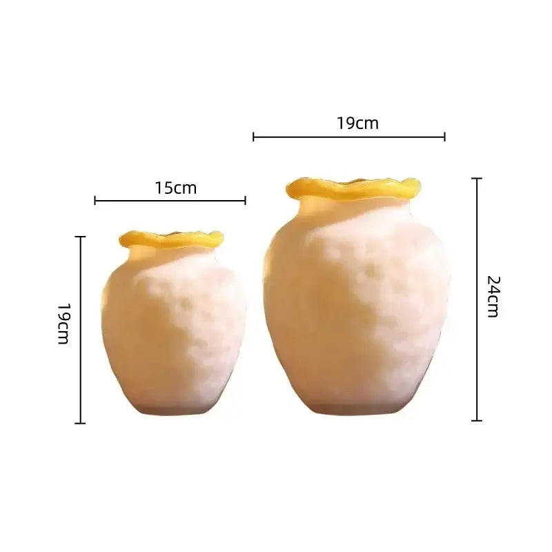 Cream-colored ceramic vases with textured surfaces and yellow-rimmed openings for decorbites colorful frosted glass decor