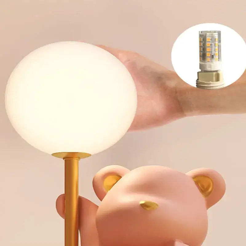 A soft white spherical lamp with a gold stem featuring led bulb for bear princess desk night use