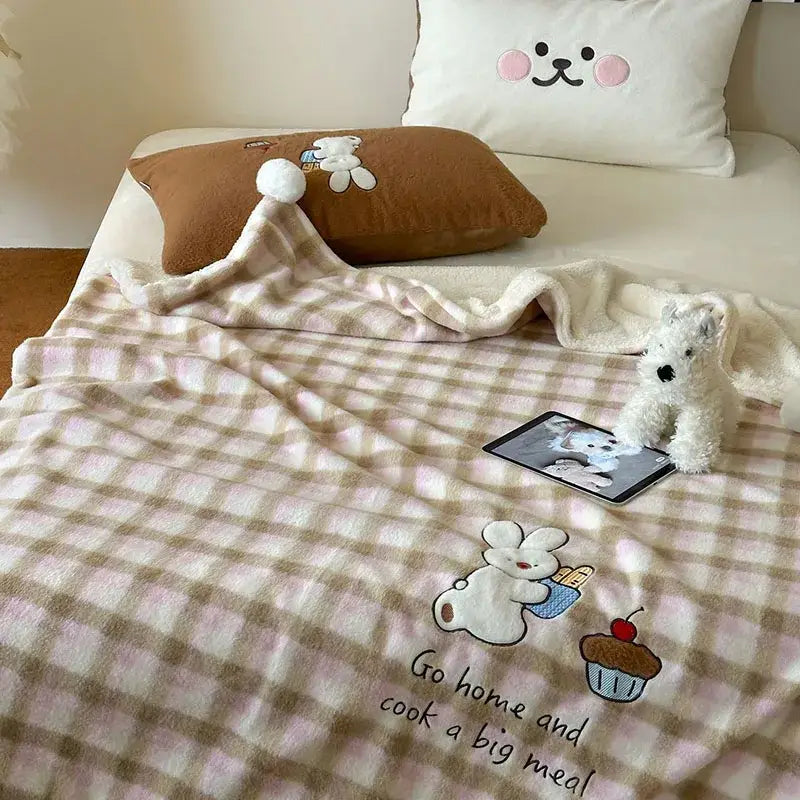 Cozy pink and beige cartoon patch woolen blanket with embroidered bunny cupcake text and fur balls decorbites decor
