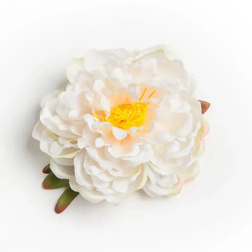 A delicate white big peony headwear with yellow center and pink undertones made of synthetic fabric artificial flowers for wedding decoration
